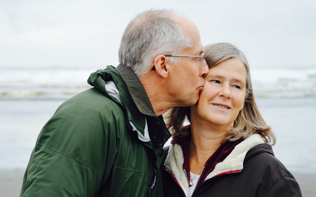 Older couple at Massachusetts beach contemplating which nursing home will be best for them
